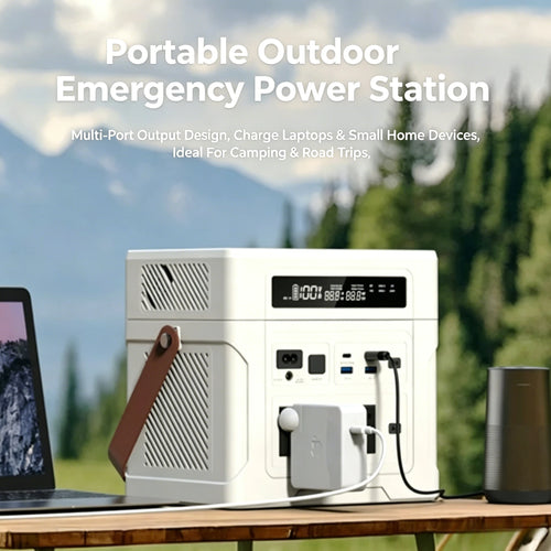 White portable power station with brown strap, LCD display, and multiple ports charging devices on a table outdoors.