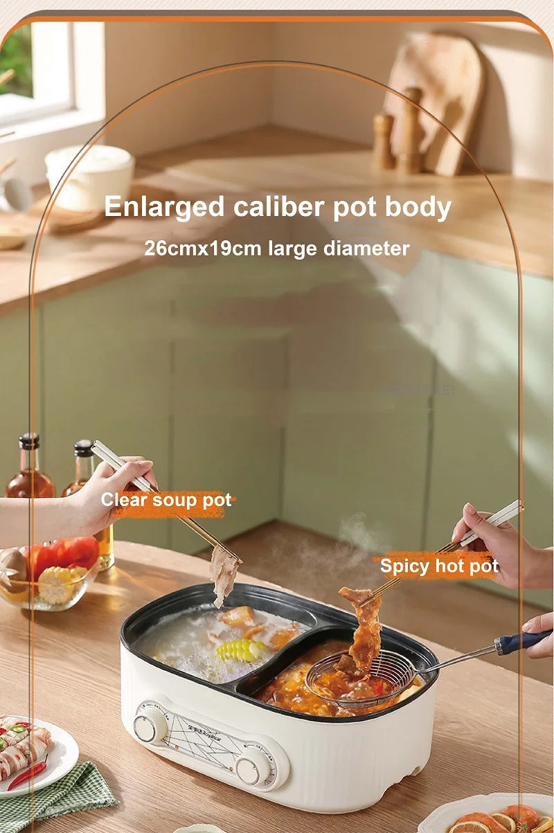 White electric hot pot with two compartments filled with soup, lid partially open