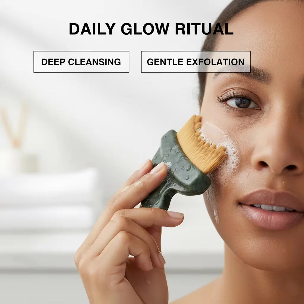A person using a dark green, stone-handled facial brush with soft bristles to cleanse their cheek with soap suds.