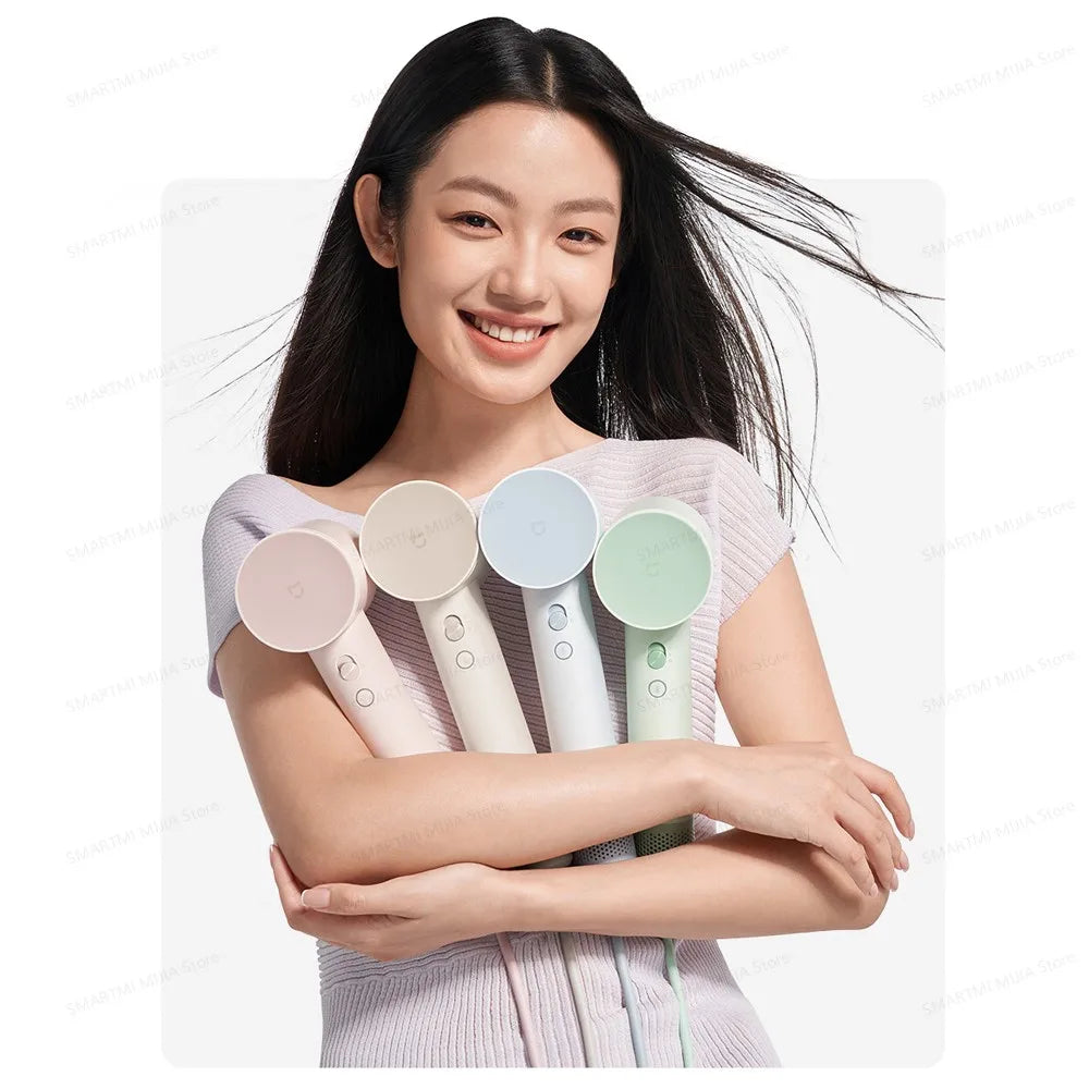 Woman holding four colorful Xiaomi MIJIA high-speed hair dryers with lightweight, compact, modern ergonomic design.