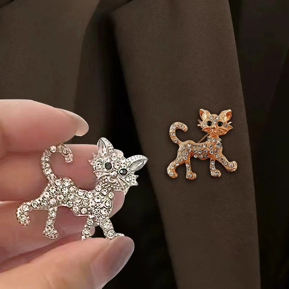 Sparkling crystal cat brooch pins in gold and silver, perfect gift for cat lovers to accessorize coats or bags.
