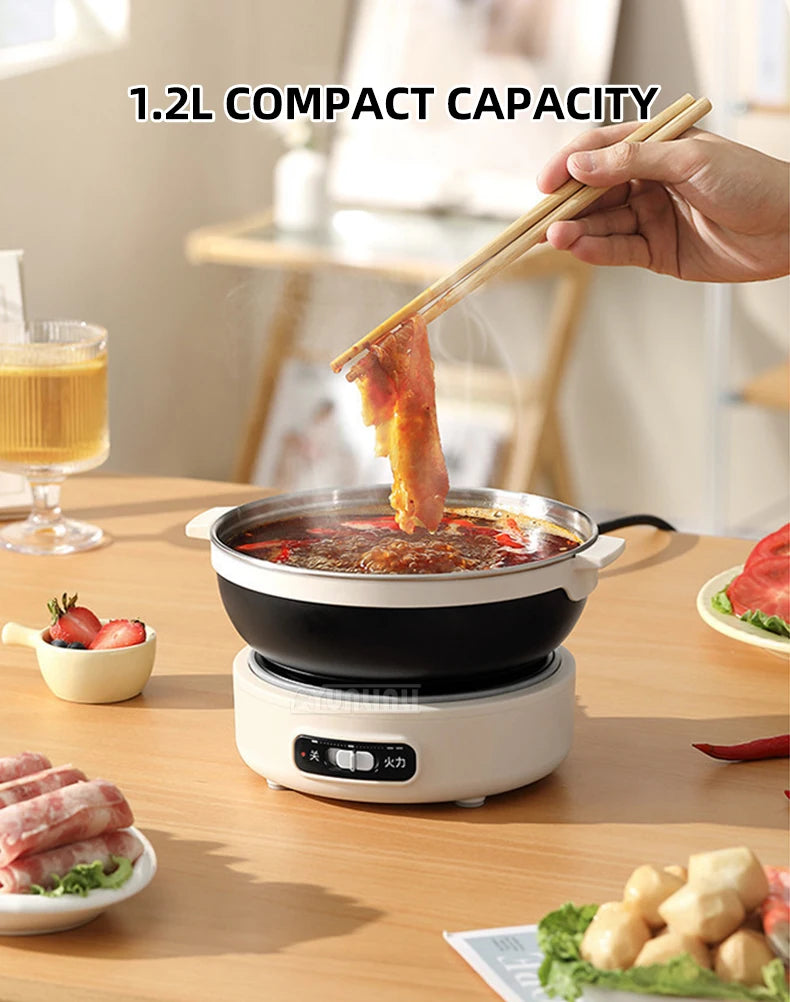 Portable split electric cooker, black pot with lid, hot liquid being poured