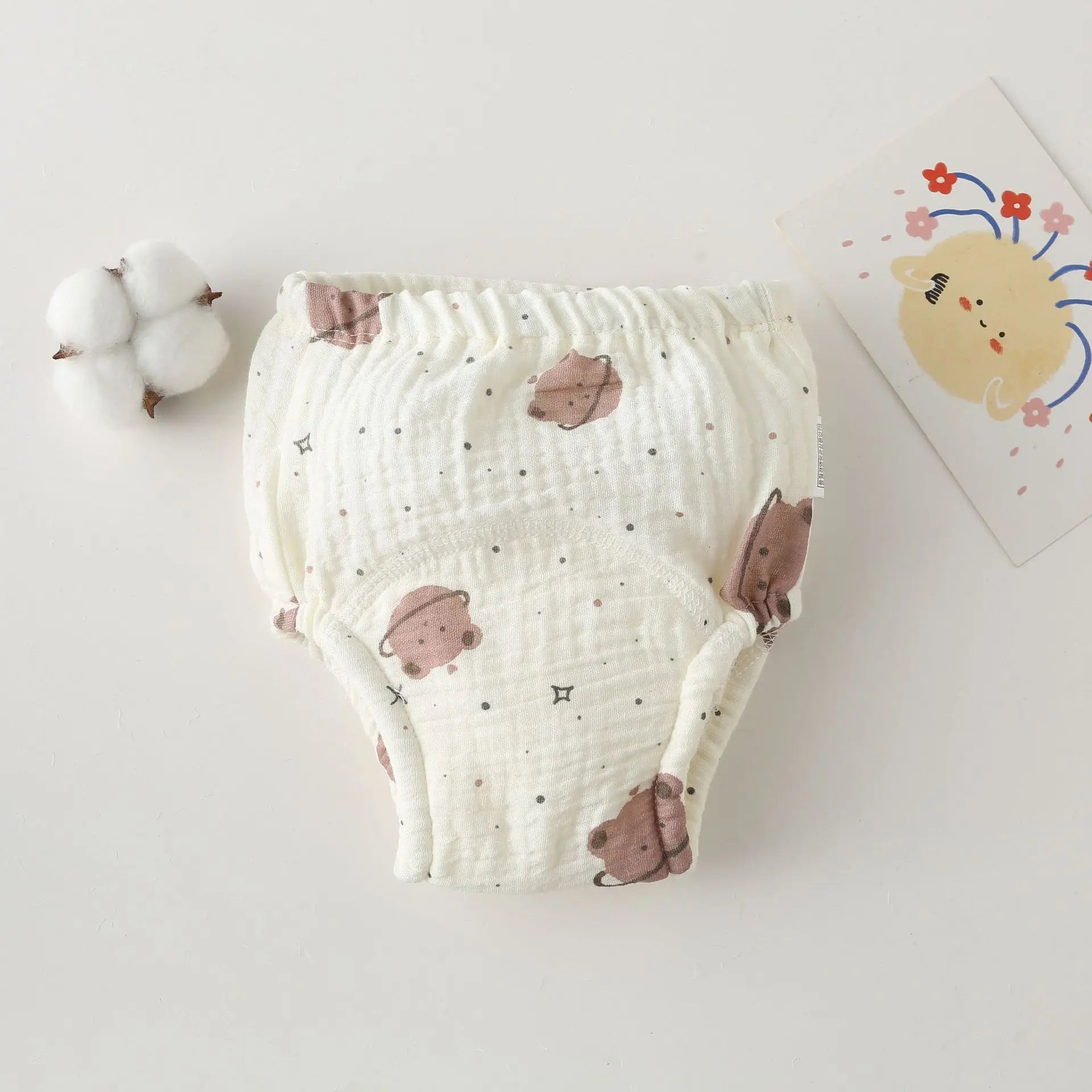 Cotton baby training pants diaper with cute bear print and soft muslin texture for infant potty training.