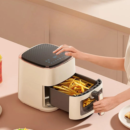 White air fryer with open drawer showing fries, top control panel and pull handle visible