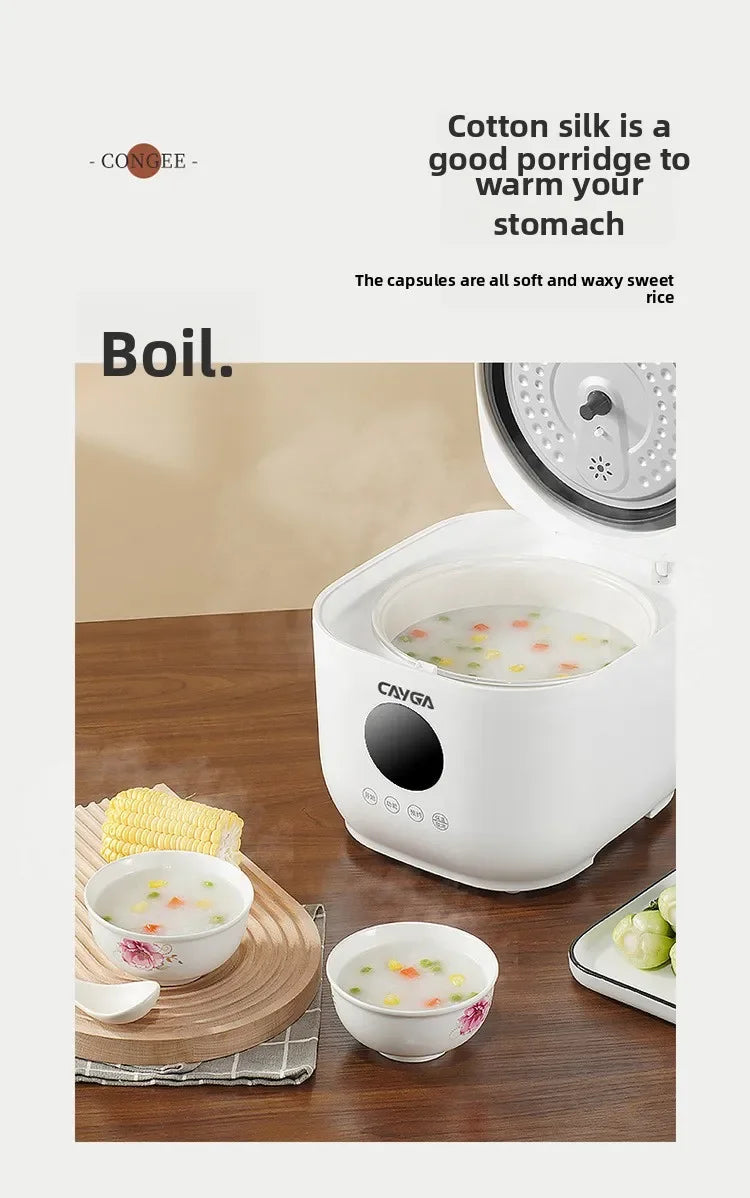 White mini electric rice cooker with lid open, steaming soup or rice contents inside