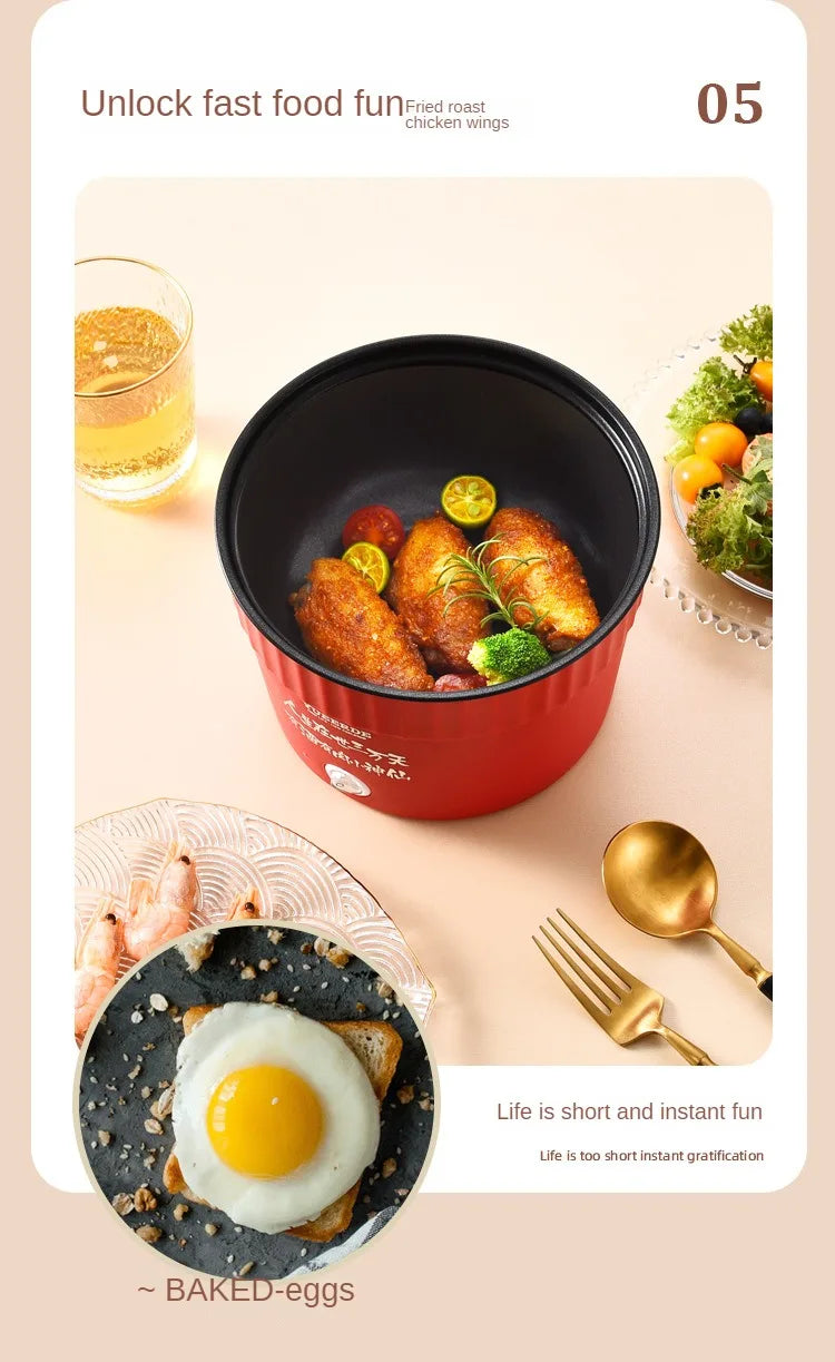 Red mini electric hot pot filled with simmering meatballs and vegetables