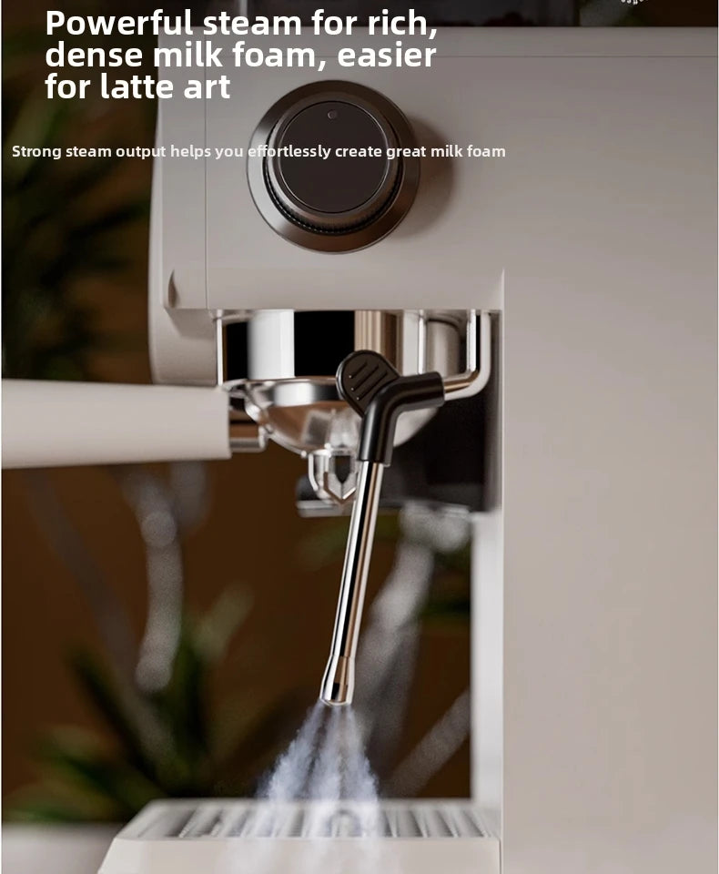 White espresso machine with stainless steel steam wand releasing steam for milk frothing and latte art.