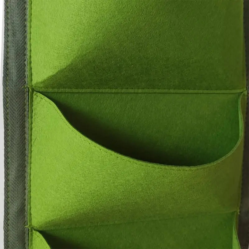 Close-up of a green wall grow bag pocket with curved front panel