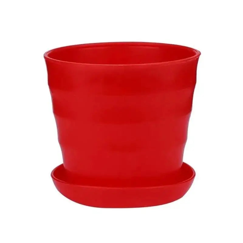 Red plastic flower pot with matching saucer, smooth matte finish