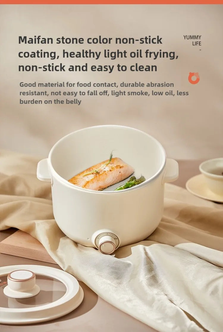 White electric multi cooker with non-stick pot, fish inside for steaming