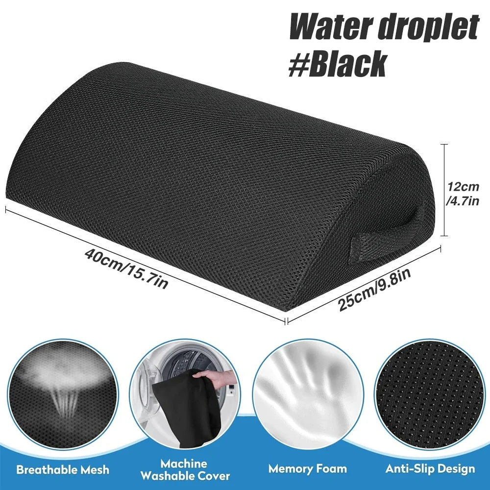 Black ergonomic under-desk foot rest with memory foam, washable mesh cover, and non-slip base for office foot support.