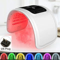 White arched LED facial rejuvenation device emitting red light, with a control panel and US plug inset.