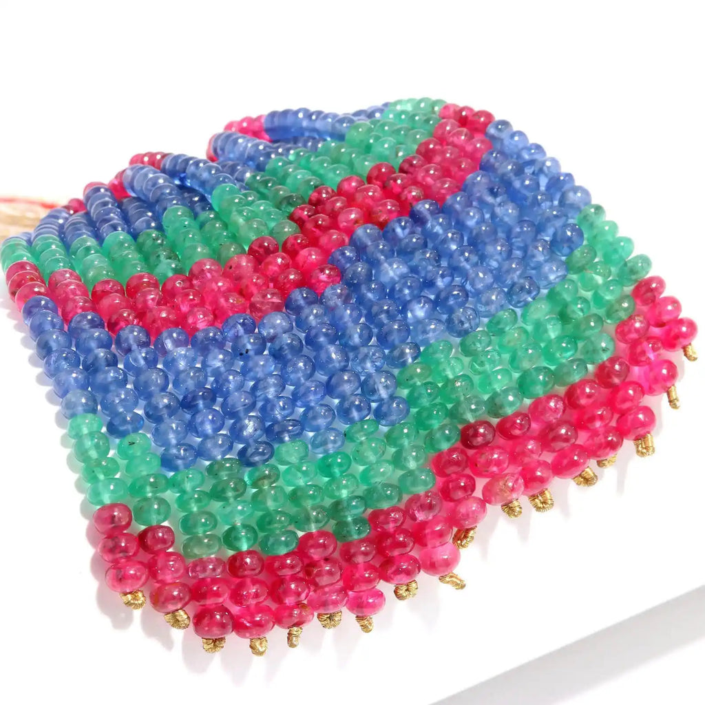 Multicolor rondelle bead strand with 4mm smooth beads in blue, green, and pink, with gold tips.