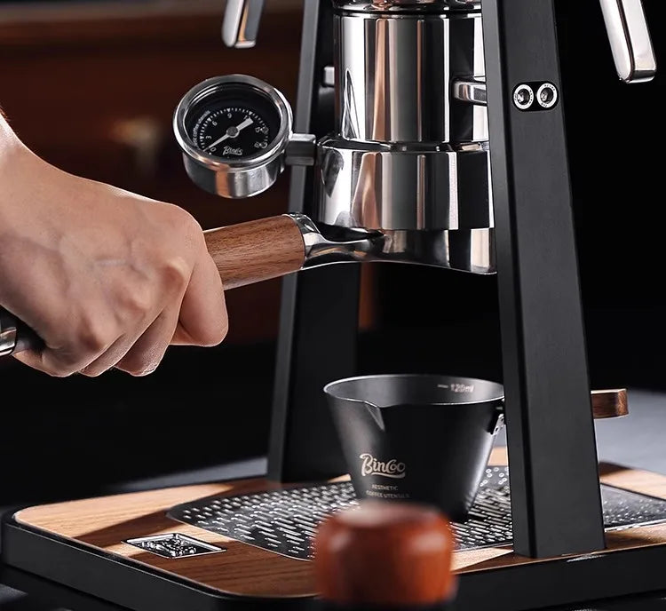 Bincoo manual espresso machine with chrome body, wood handle, pressure gauge, and 120ml black collection cup.