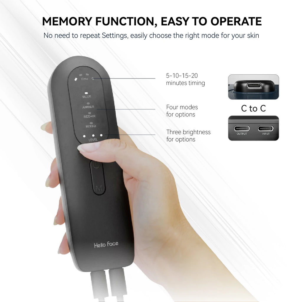 A hand holds a black, oblong LED face mask remote with touch buttons, LED indicators, and USB-C ports.