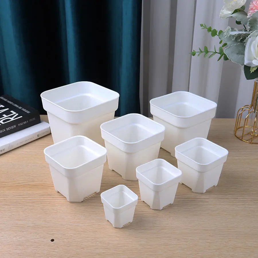 Assorted small white square planters with thick walls, nesting stackable flower pots