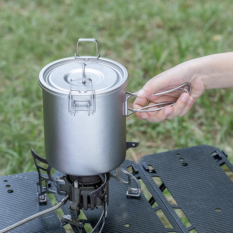 Titanium rice cooker pot with lid and metal side handles, viewed from front