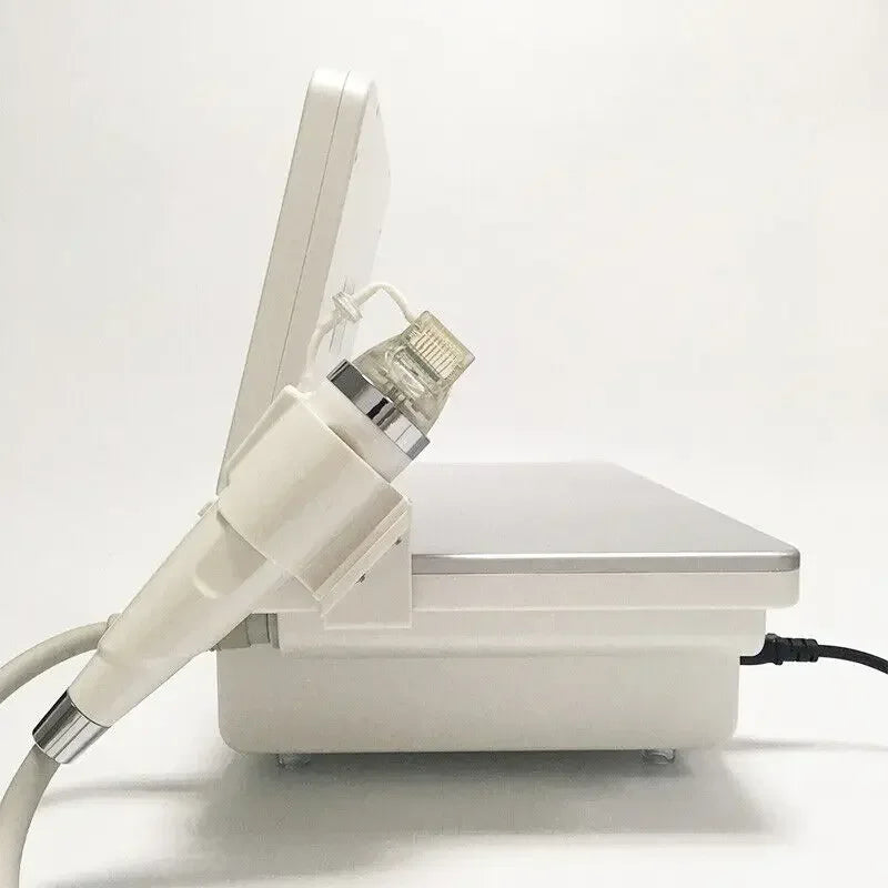 Portable fractional RF skin tightening device with handheld applicator for wrinkle removal and skin rejuvenation.