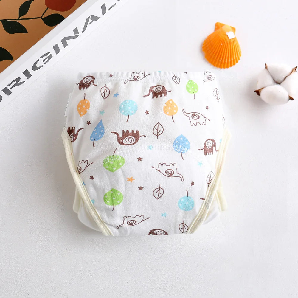 Reusable cloth baby training diaper with cute elephant and leaf print design on white cotton fabric.