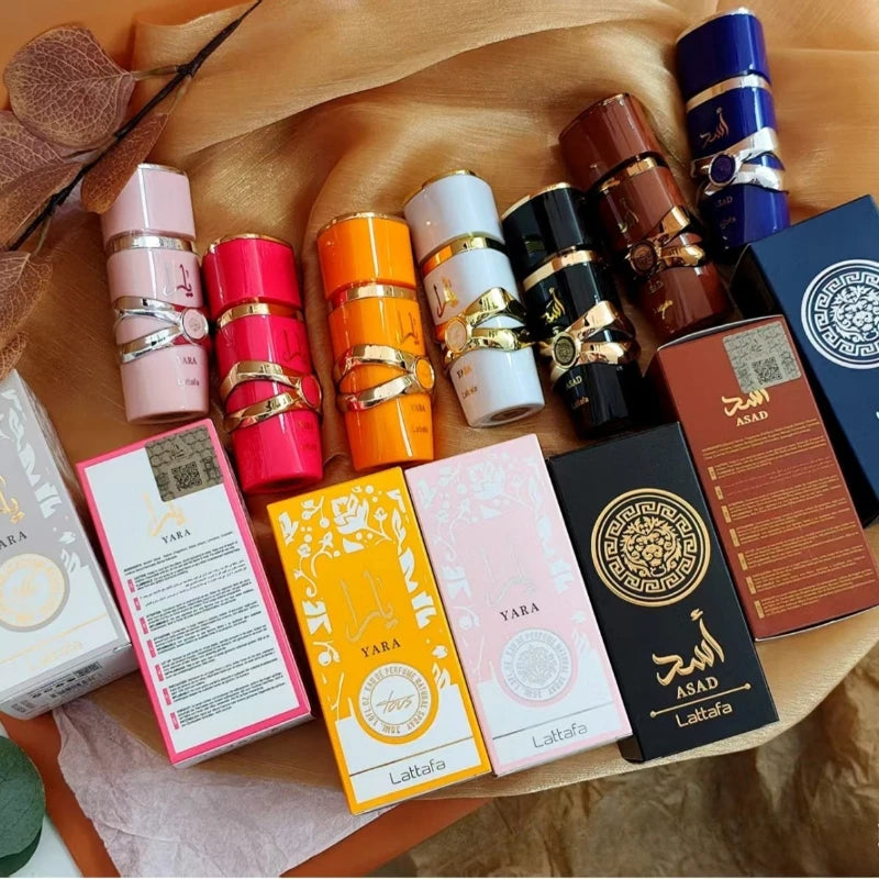 Lattafa Yara 30ml EDP: Floral, Orchid, Oud fragrance for men and women. Stylish cylindrical bottles in vibrant colors.