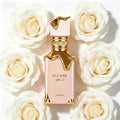 Lattafa Eclaire perfume bottle with pink finish and gold dripping design, surrounded by white rose flowers.