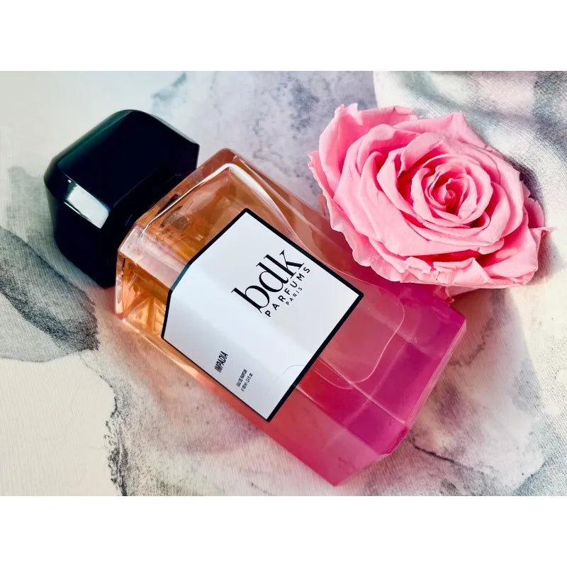 BDK Parfums Impadia EDP 100ml: Luxurious women's perfume in a rectangular glass bottle with a pink rose and black cap.