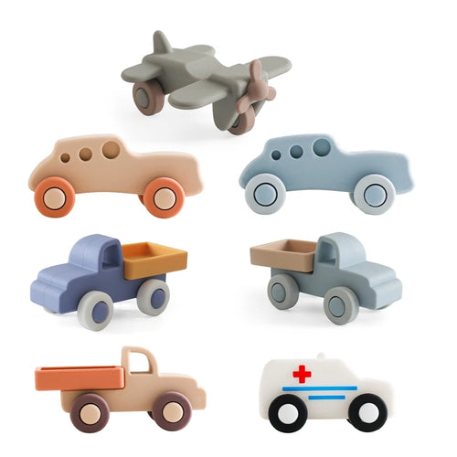 Multi-colored silicone baby teething toy set in various vehicle shapes for infant pain relief.
