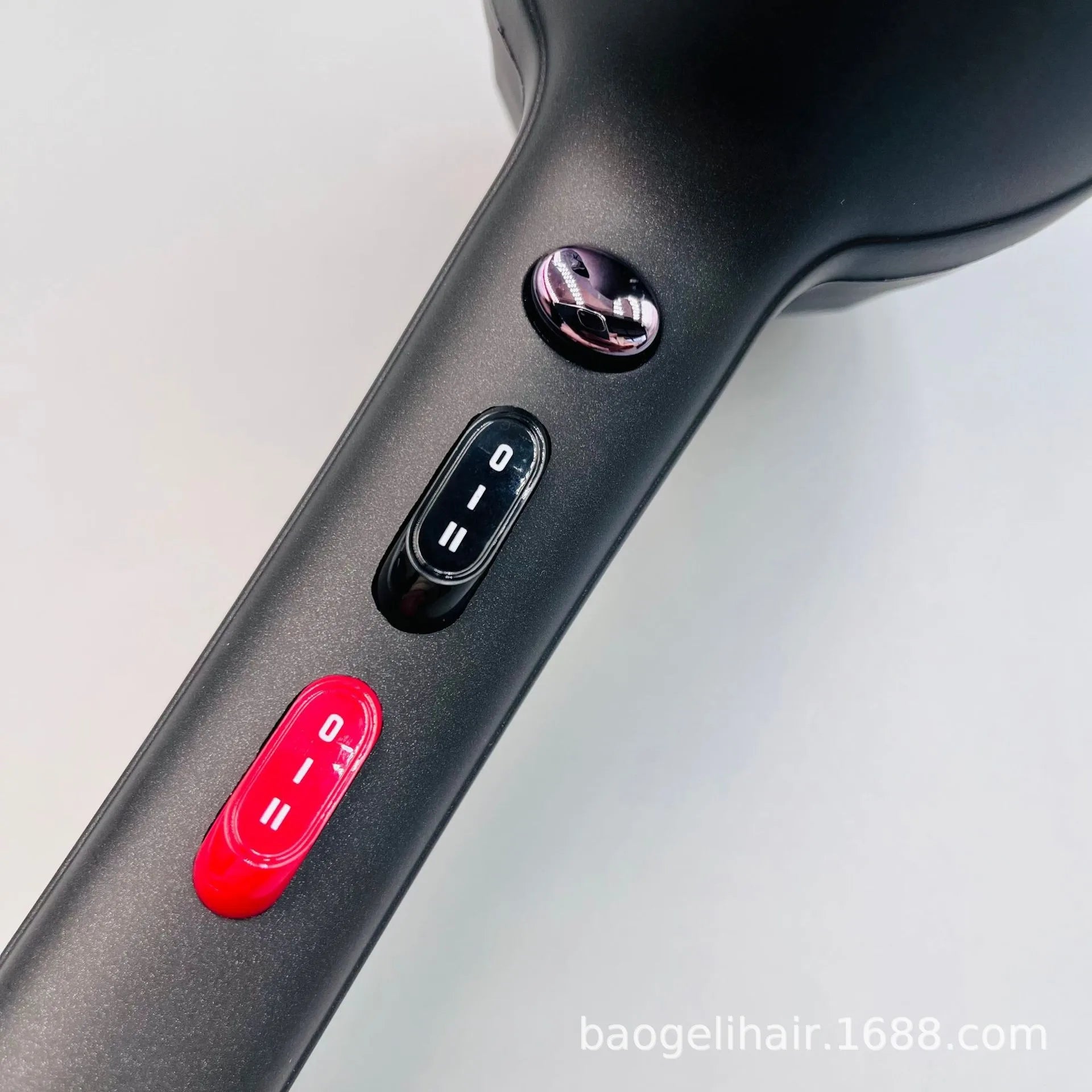 Matte black 2600W hair dryer handle featuring adjustable speed/heat settings with a distinct red control switch.