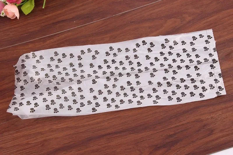 Leak-proof white dog poop bags with cute black cartoon paw prints for easy, clean pet waste cleanup.