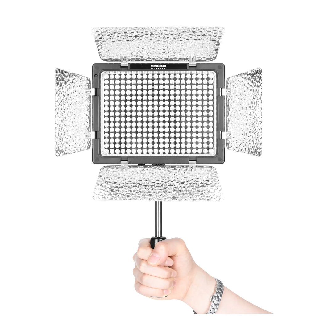 Handheld LED light panel with silver textured barn doors, mounted on a handle for video lighting.