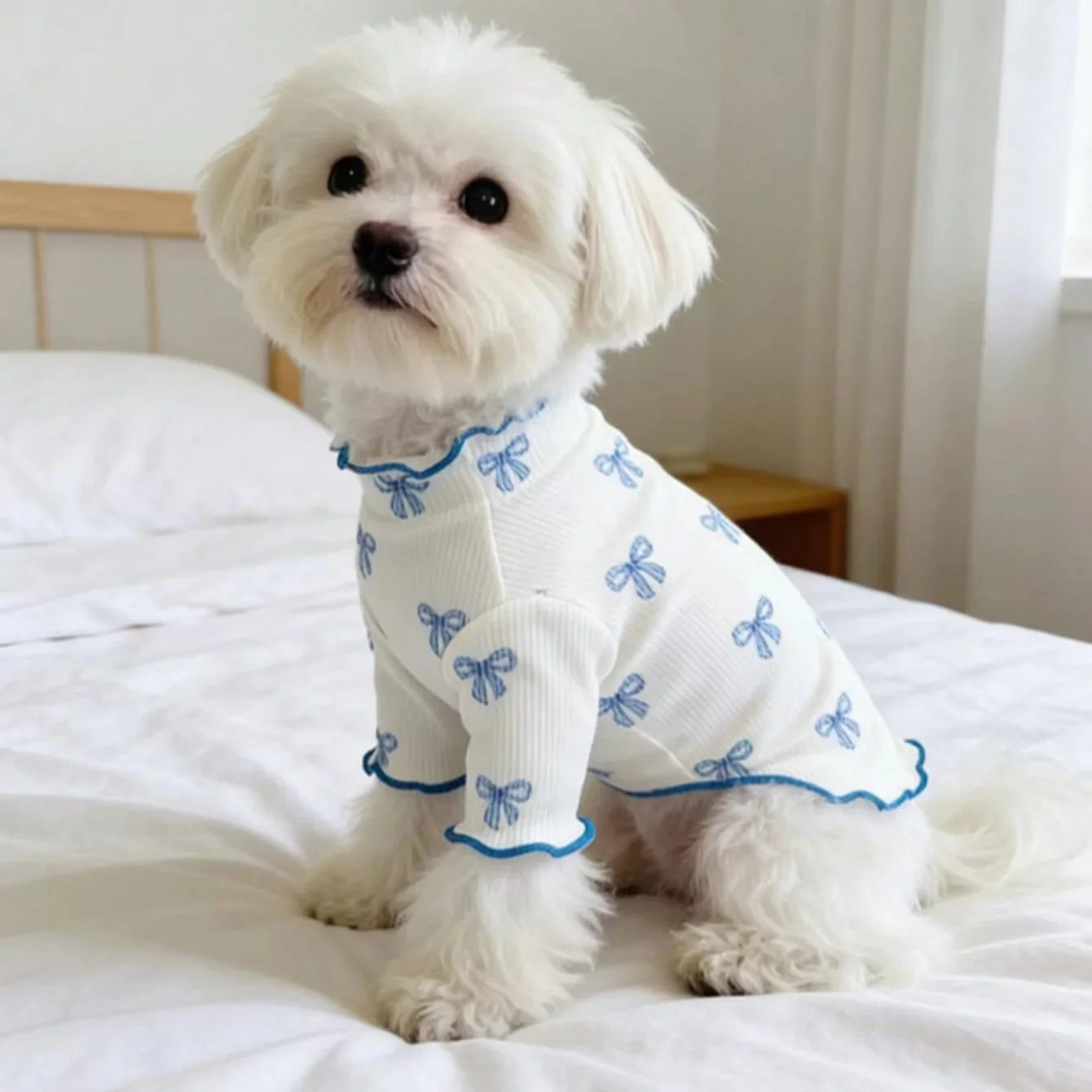 White, stretchy knit dog shirt with blue bow tie print for comfortable, breathable pet fashion.