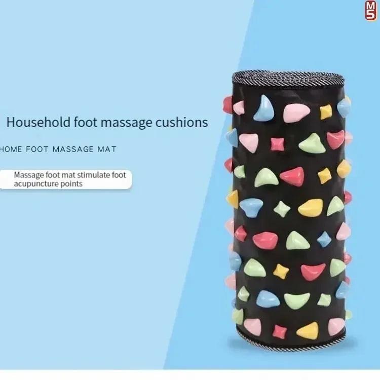 Black cylindrical foot acupressure massage mat with colorful stimulation stones for reflexology and pain relief.