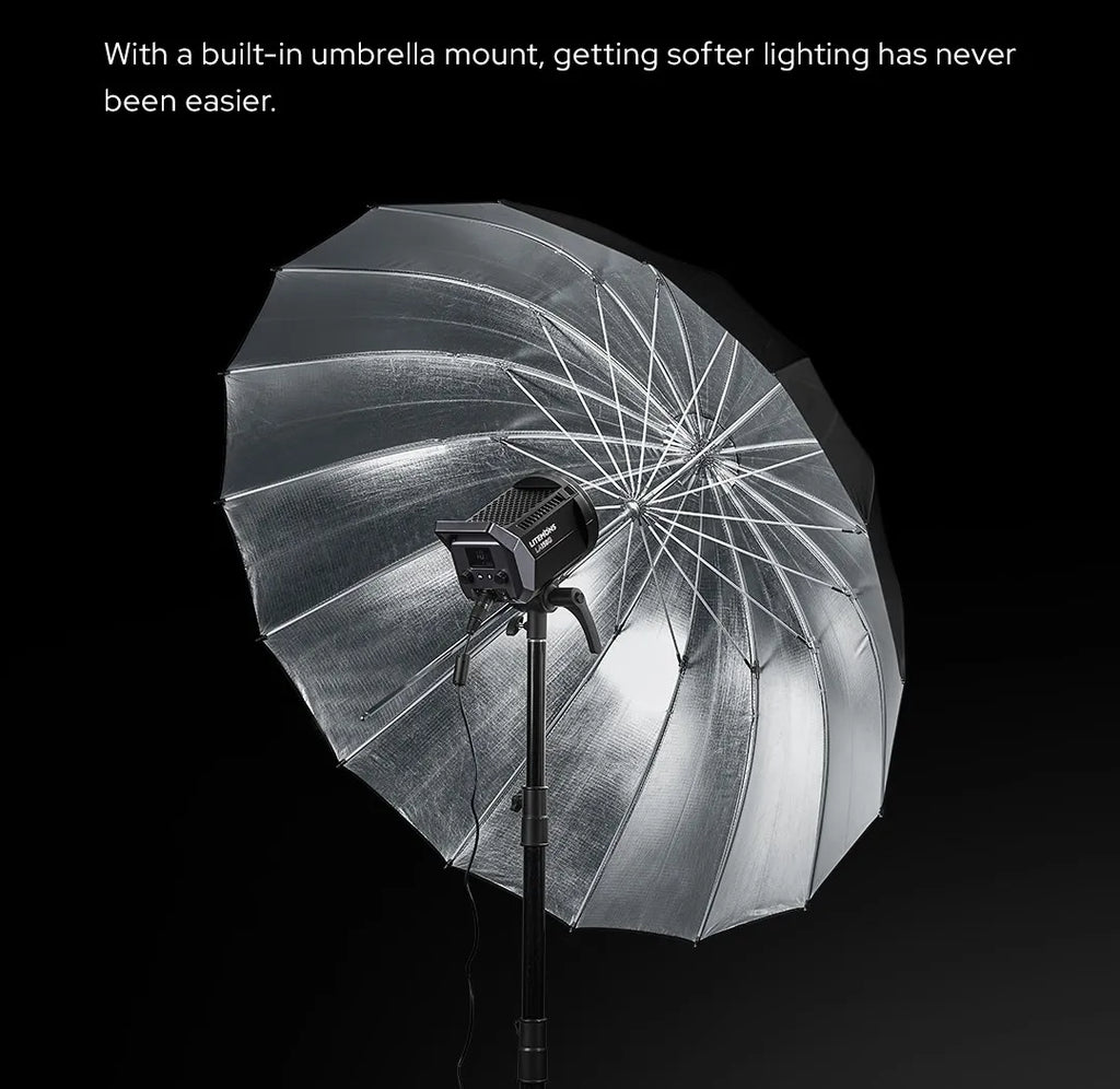 Studio LED video light mounted on a stand with a large, silver, reflective photographic umbrella for soft lighting.