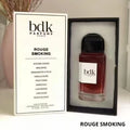 Rouge Smoking 100ml eau de parfum in a glass bottle with a black cap, displayed next to its white rectangular box.