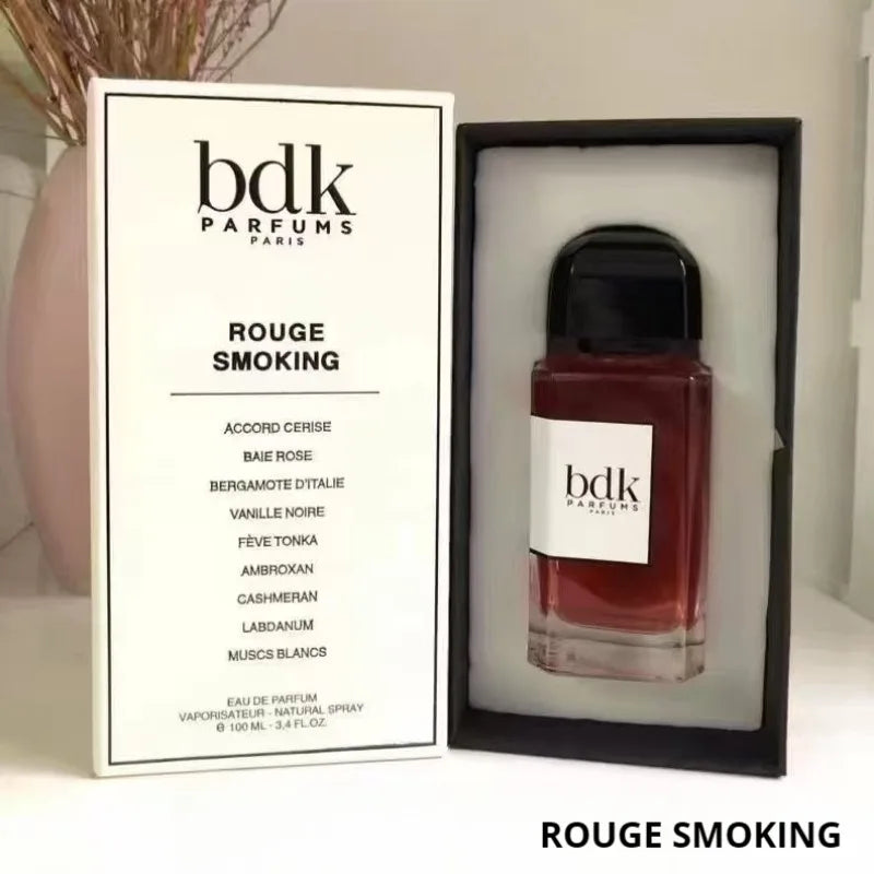 Rouge Smoking 100ml eau de parfum in a glass bottle with a black cap, displayed next to its white rectangular box.