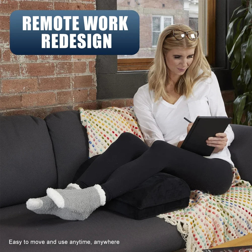 Woman sitting on a sofa using a black adjustable 2-in-1 ergonomic footrest for back, knee, and leg pain relief.