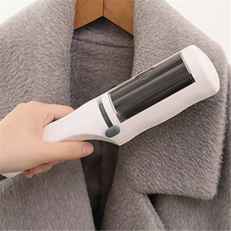 White self-cleaning electrostatic lint brush removing dog and cat hair from a grey coat for easy pet hair cleanup.