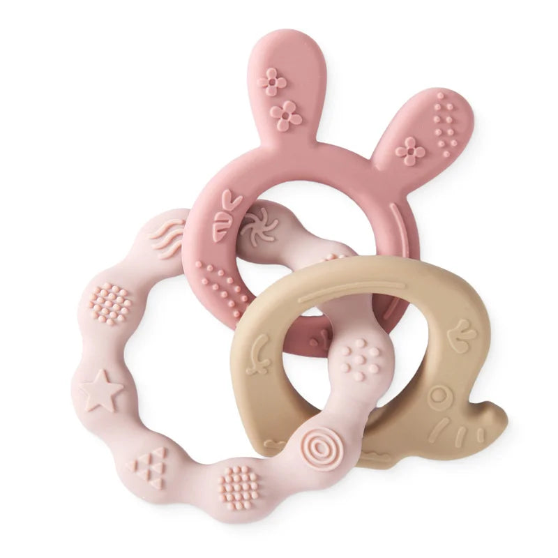 Pink and beige silicone baby teething rings for soothing relief.
