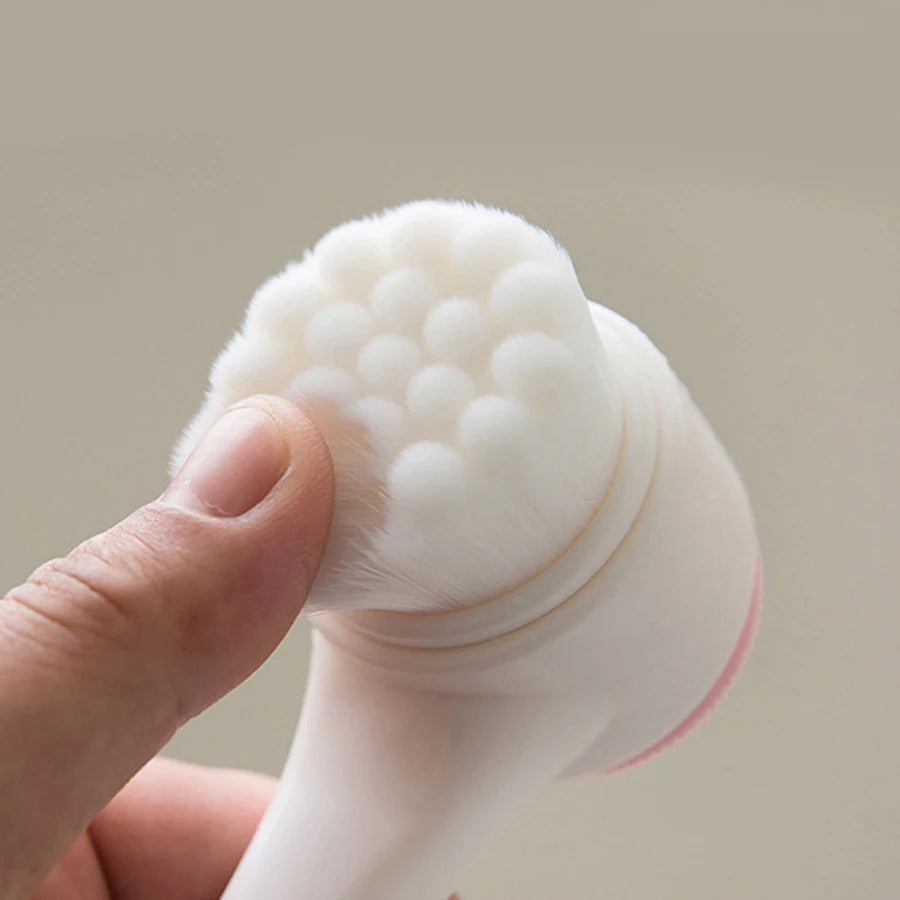 Light beige manual facial cleansing brush with soft bristles for pore exfoliation and daily skincare.