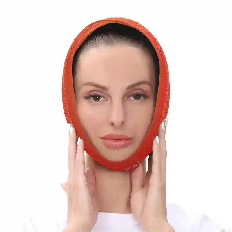 A person wears an orange, mesh-textured, oval-shaped adjustable heated wrap around their chin and head.