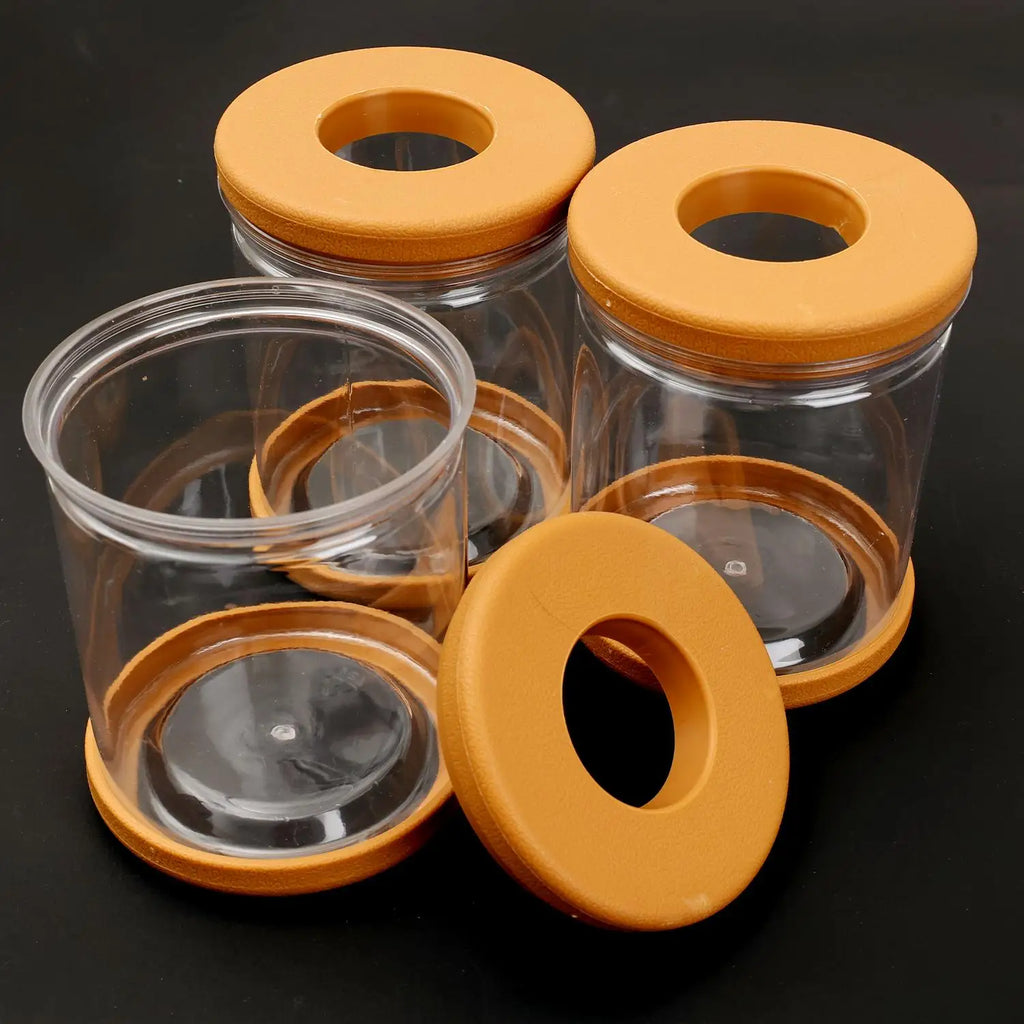 Transparent hydroponic plant pot containers with orange lids and non-slip bases, shown without plants
