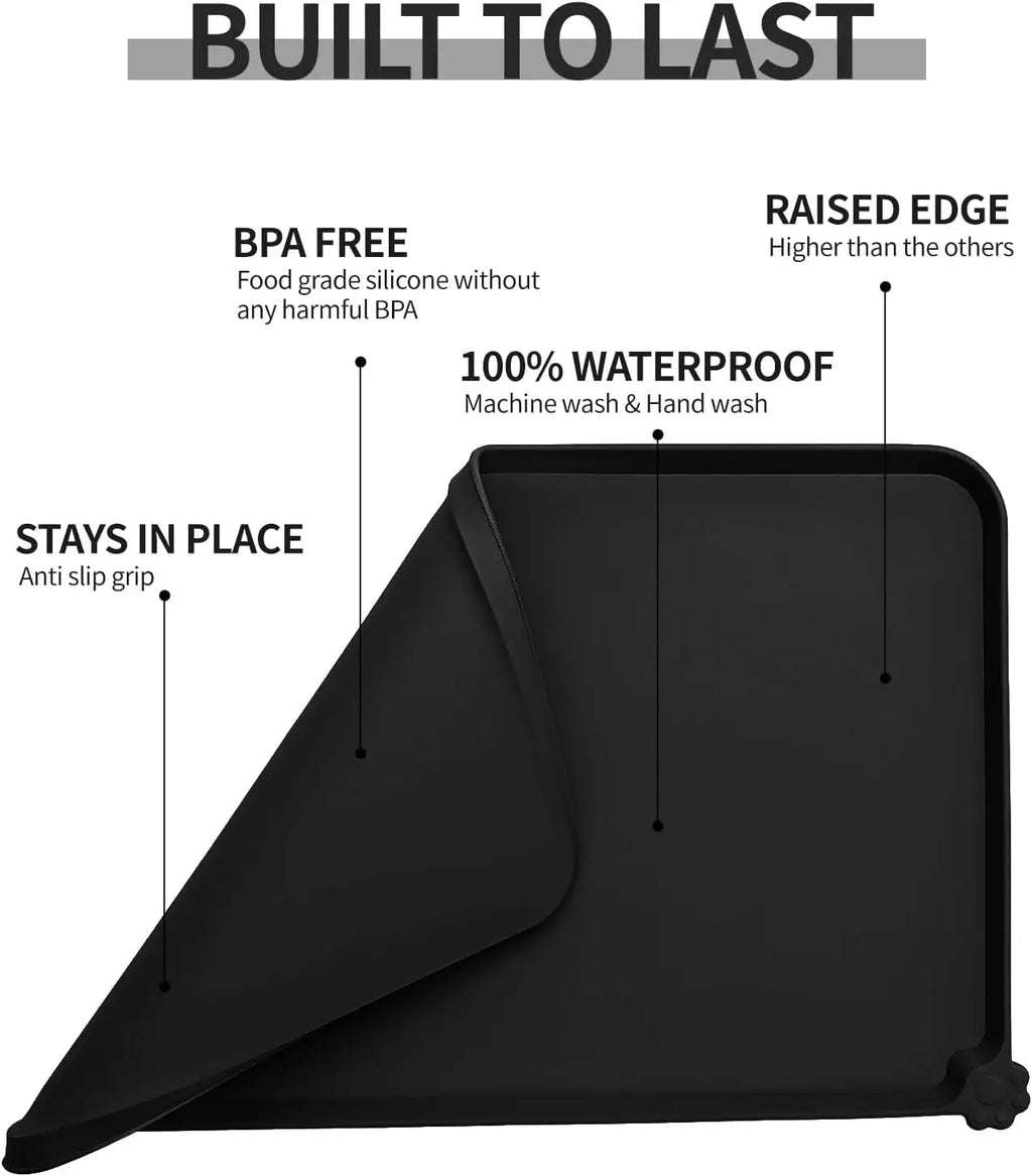 Black waterproof silicone pet feeding mat with raised edges for mess-free cat and dog bowl placement.