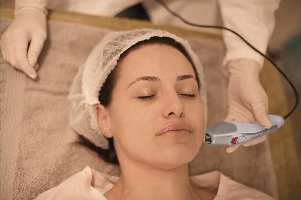 Korean Dot Matrix RF skin lifting device being used for facial rejuvenation on a client in a spa.