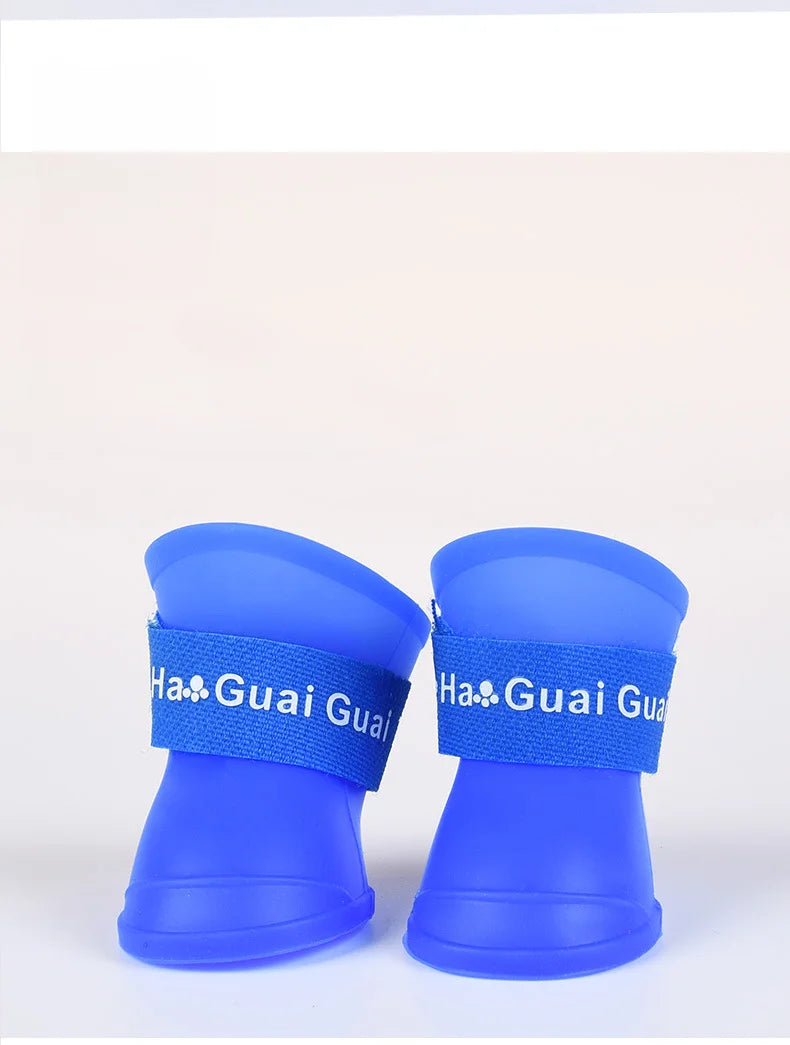 Blue waterproof non-slip dog rain boots with soft silicone material and secure straps for dry outdoor pet paws.