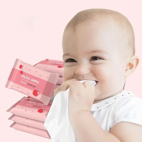 Baby holding a 10-count pack of gentle Fruits Wipes, pink apple-themed baby care cleansing wipes.