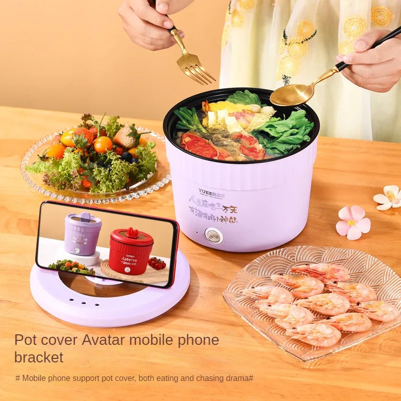 White and purple electric hot pot on counter, with lid handle and toppings