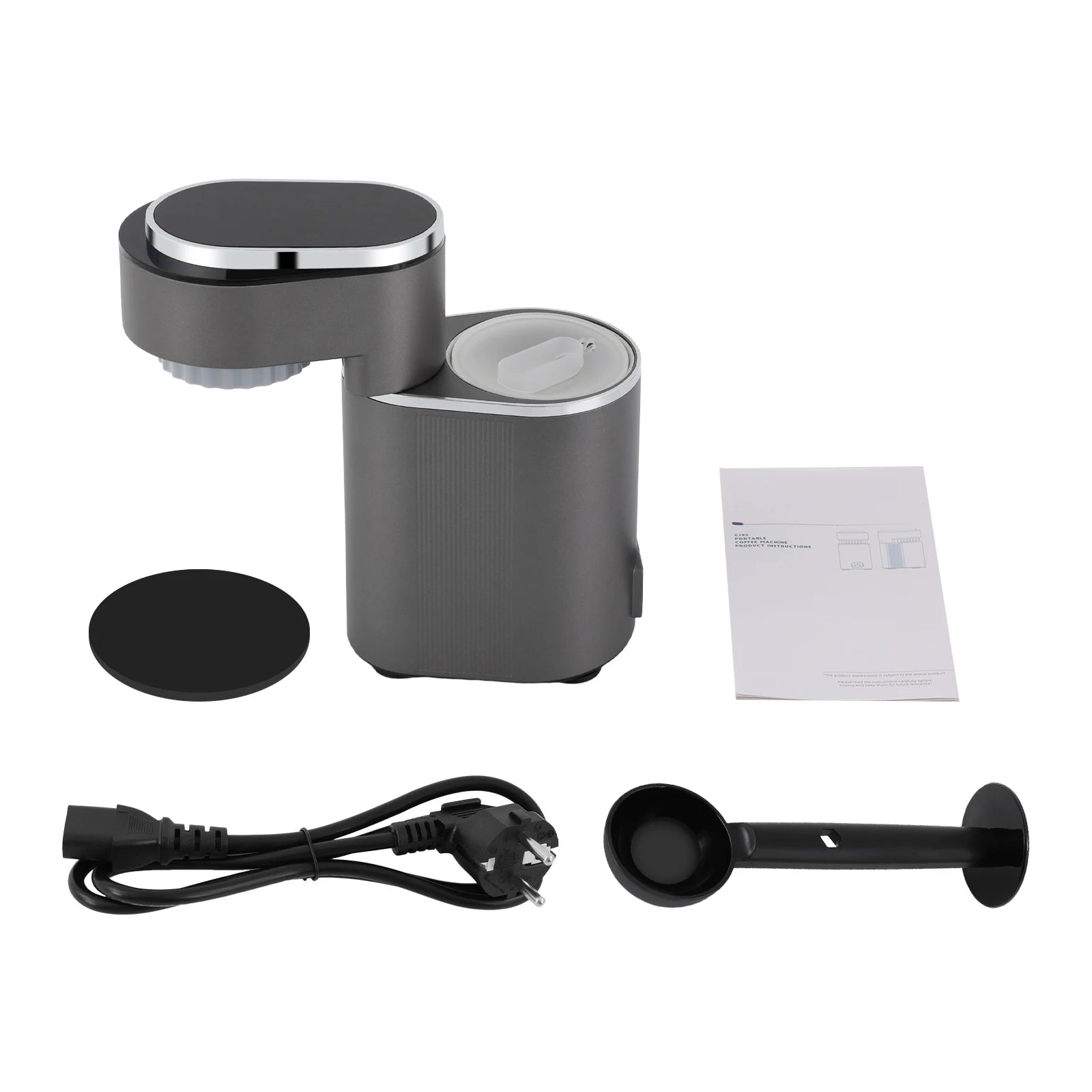Portable dark gray electric coffee maker set with power cord, measuring scoop, and user manual on white background.