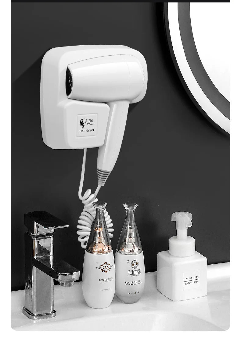 White wall-mounted bathroom hair dryer with coiled cord and easy mount bracket for home or hotel use.