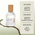 Frosted glass perfume bottle with wooden cap, clear liquid, and white label on a branch with white tea scent notes.