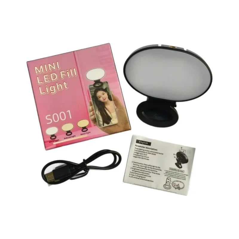 Mini LED fill light with a black clip-on circular lamp, USB-C charging cable, and instructional packaging.